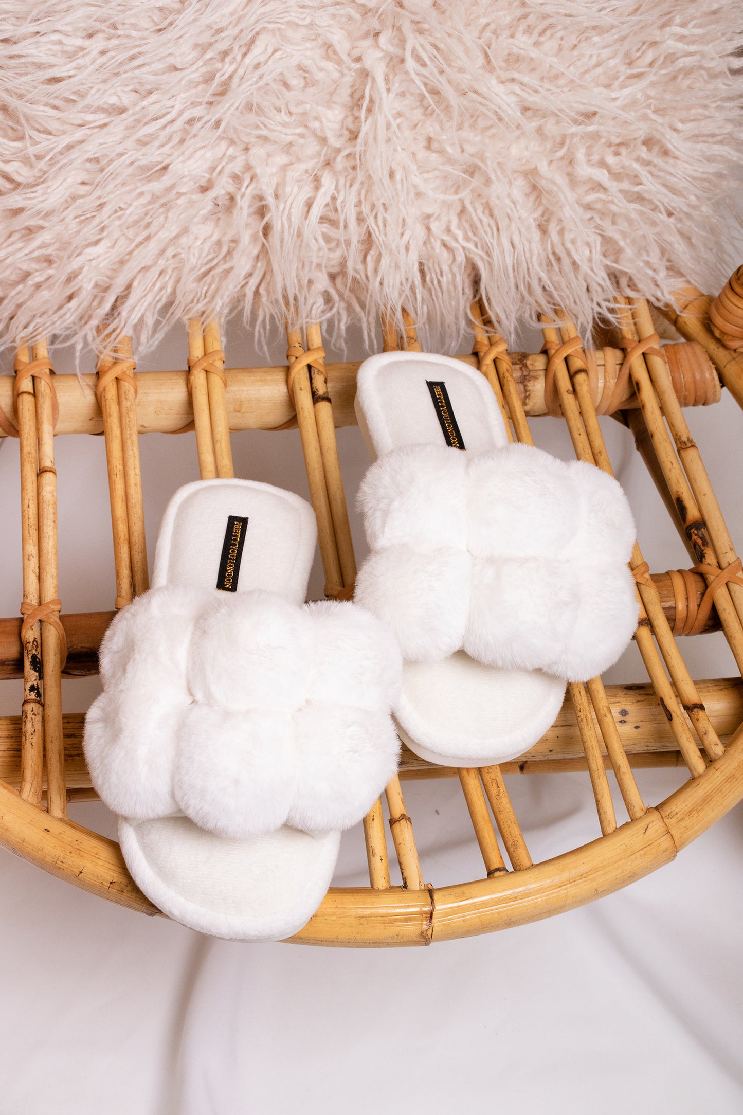 Dolly women's slider slippers in white with oversized faux fur pom poms from Pretty You London