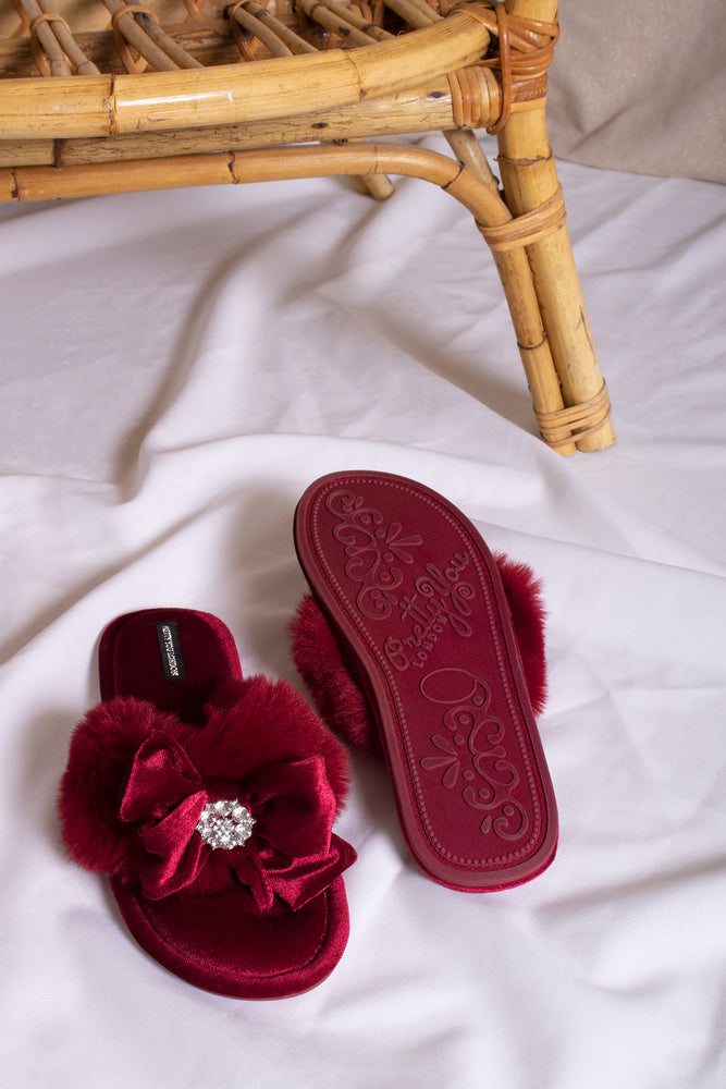 
                  
                    Amelie women's toe post slippers in red with a premium velvet bow and diamante embellishment atop a plush faux fur band from Pretty You London
                  
                