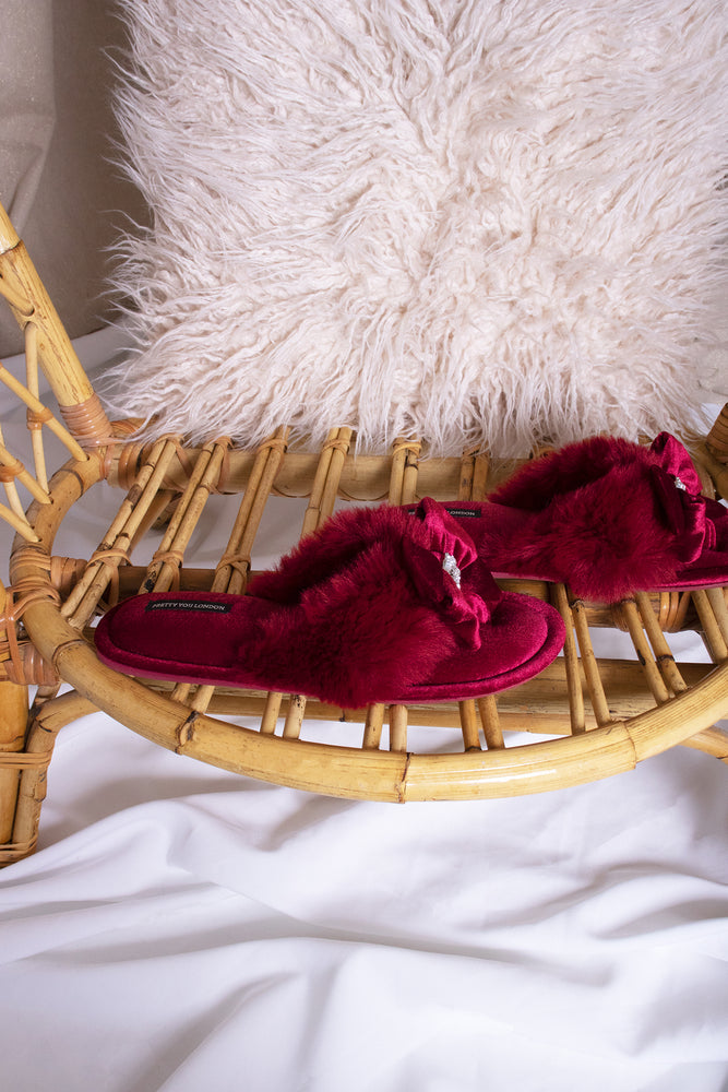 
                  
                    Amelie women's toe post slippers in red with a premium velvet bow and diamante embellishment atop a plush faux fur band from Pretty You London
                  
                