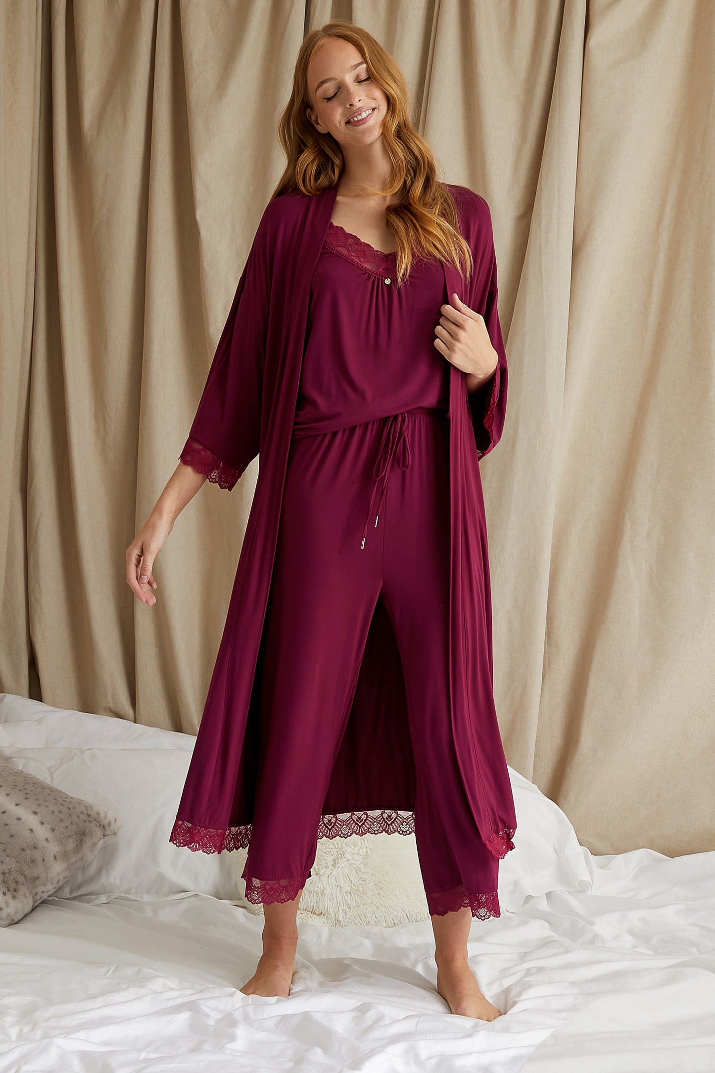 
                  
                    Women's Bamboo Lace Cami Cropped Trouser Pyjama Set in Bordeaux with delicate lace trims and adjustable straps from Pretty You London
                  
                