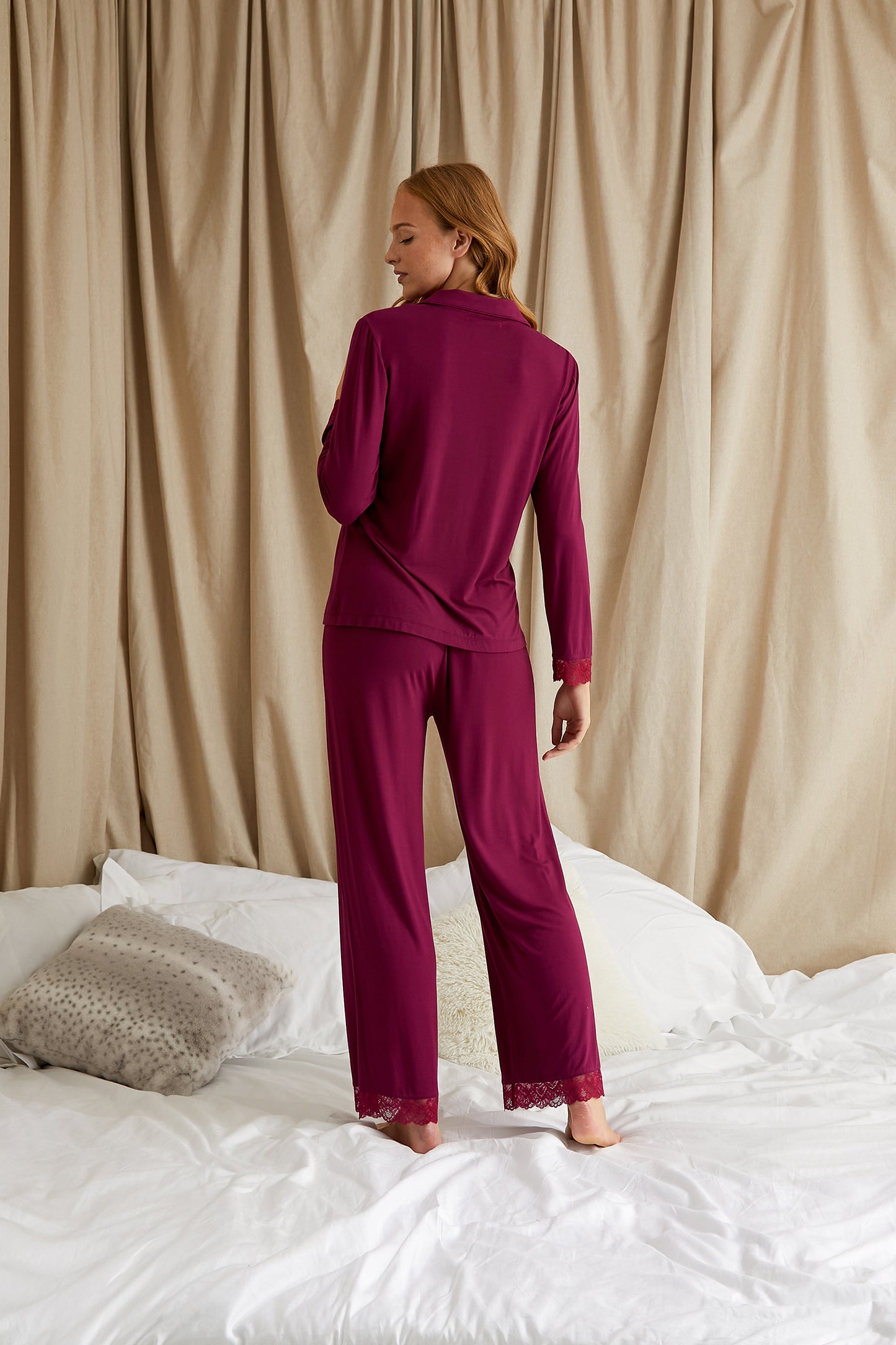 
                  
                    Women's Bamboo Lace Long Pyjama Set in Bordeaux with delicate lace trims, iridescent tonal buttons and revere collar finished with tonal piping from Pretty You London
                  
                
