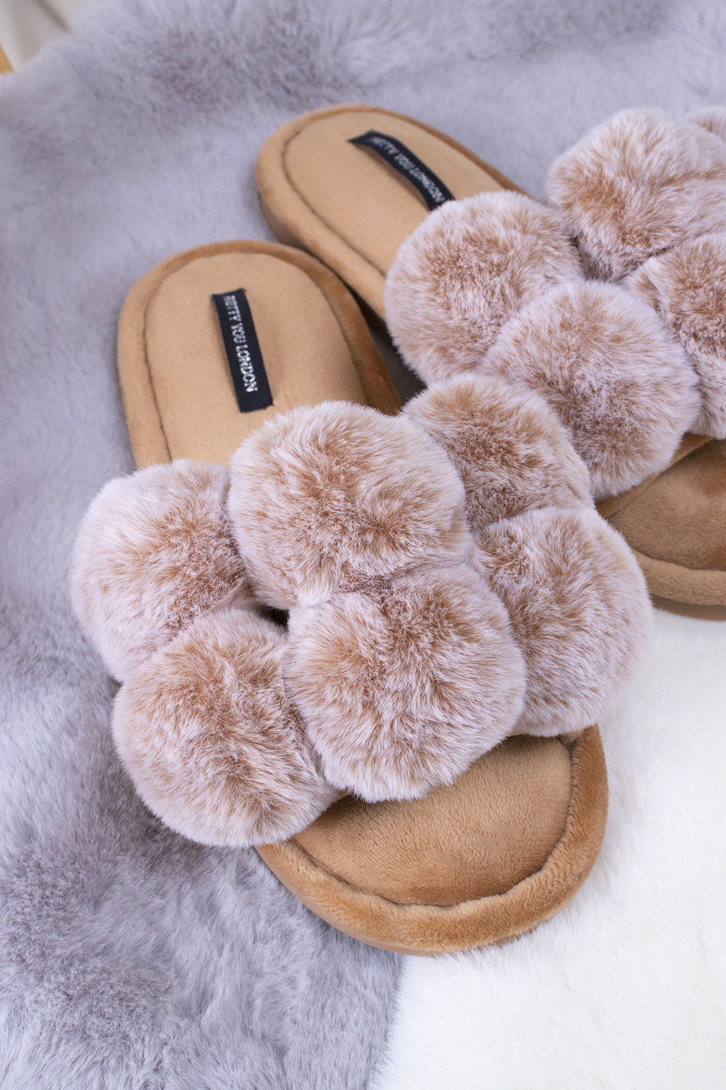 
                  
                    Dolly women's slider slippers in caramel with oversized faux fur pom poms from Pretty You London
                  
                