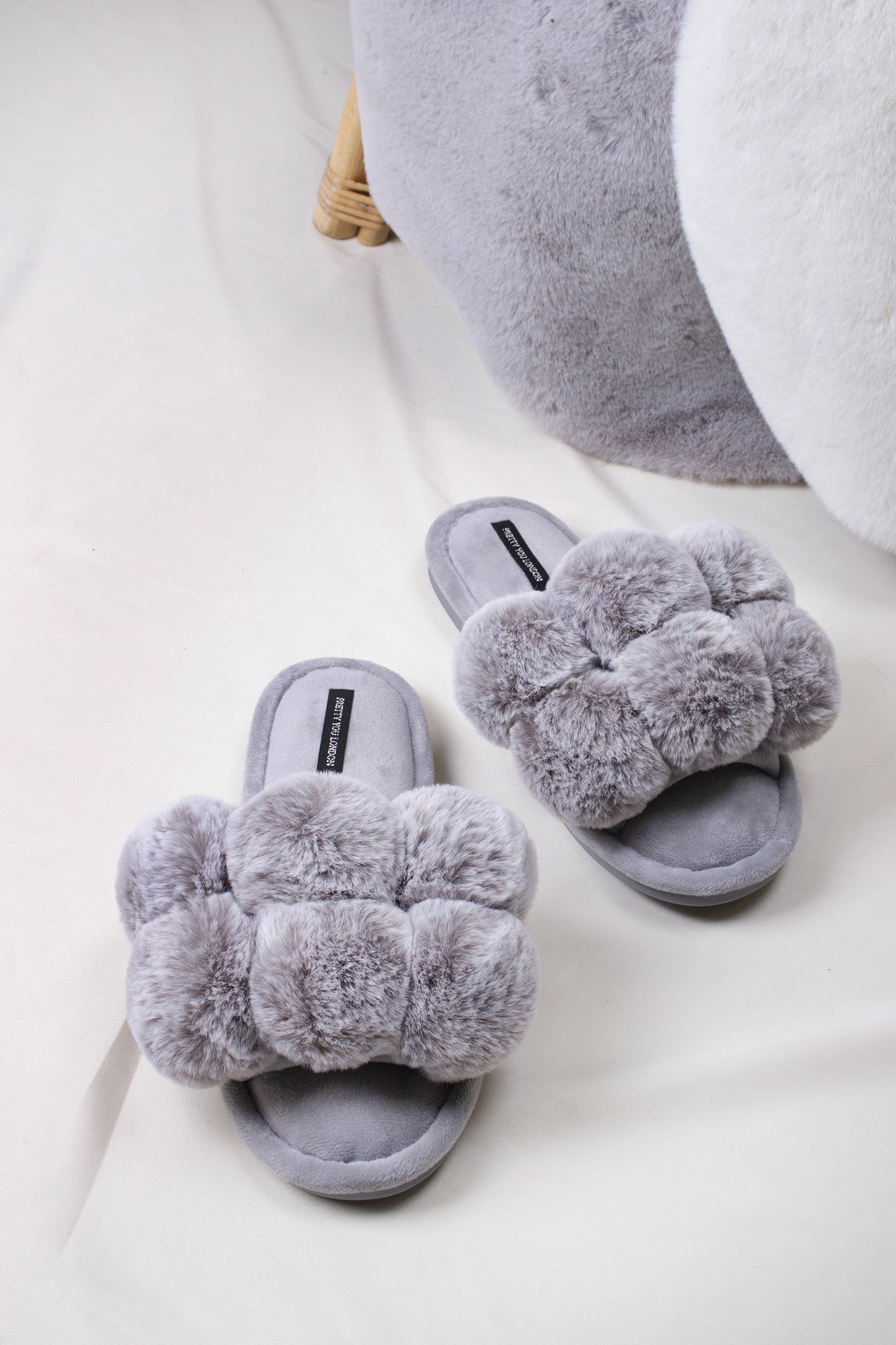 Dolly women's slider slippers in grey with oversized faux fur pom poms from Pretty You London