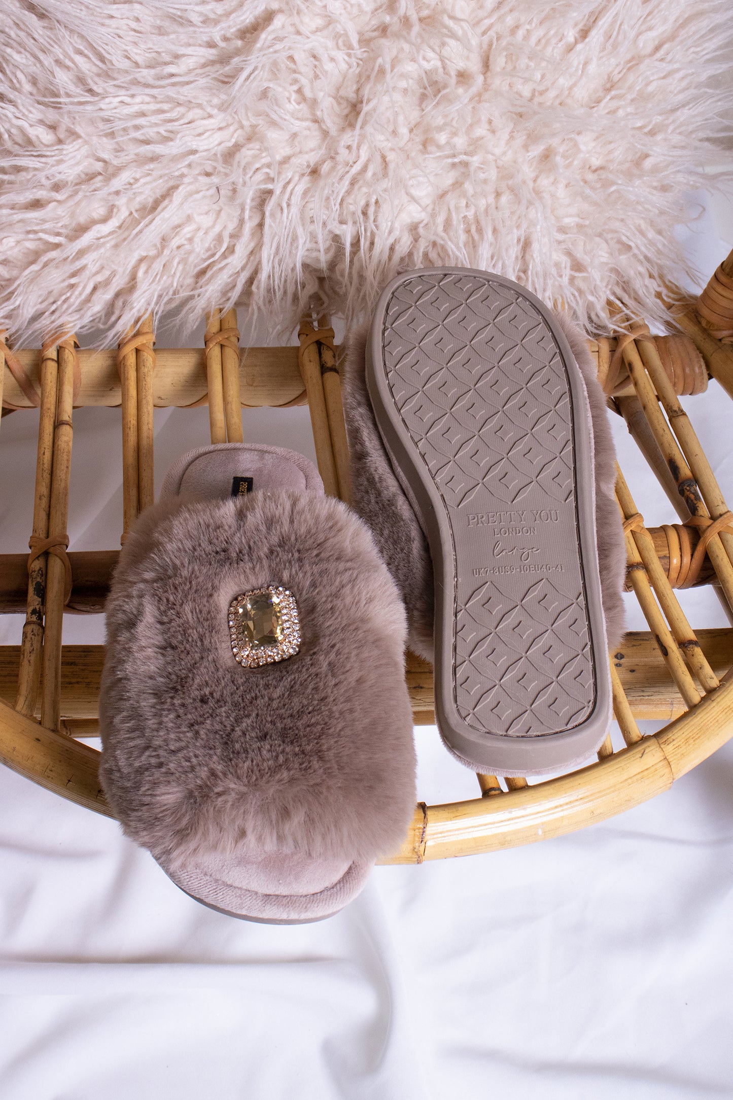 
                  
                    Fifi women's slider slippers in truffle with a crystal diamante brooch adorning the faux fur band from Pretty You London
                  
                